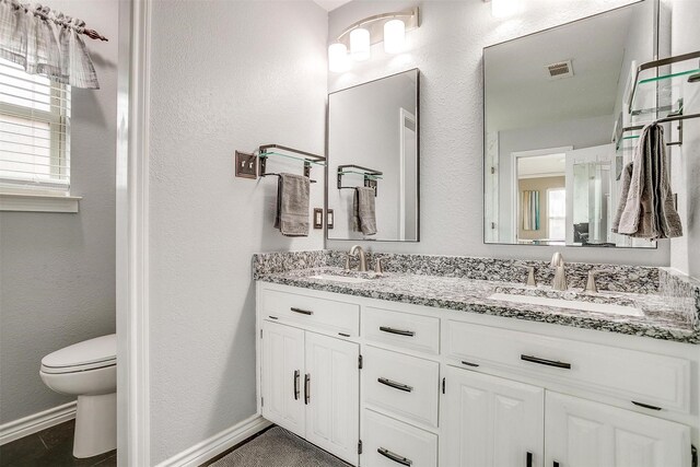 bathroom featuring vanity and toilet