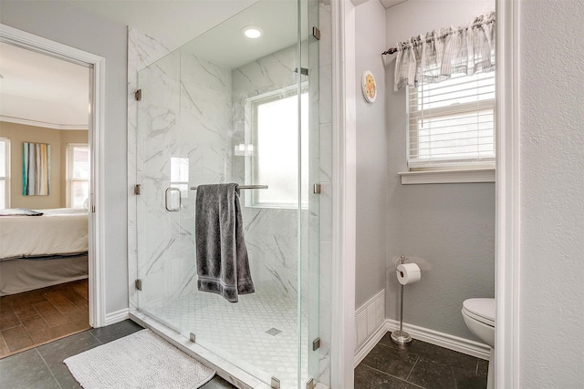 bathroom with tile patterned flooring, a healthy amount of sunlight, toilet, and crown molding