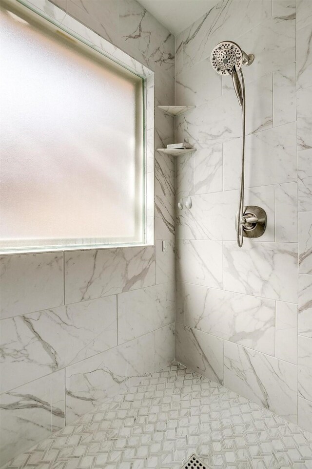 bathroom with tiled shower