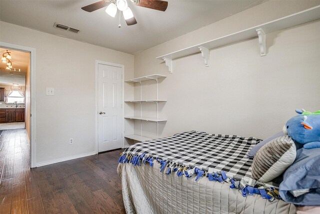 bedroom with ceiling fan, dark hardwood / wood-style flooring, and sink