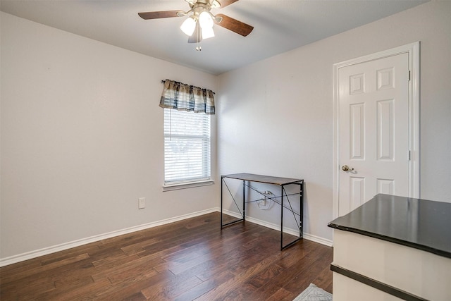 unfurnished room with ceiling fan and dark hardwood / wood-style flooring