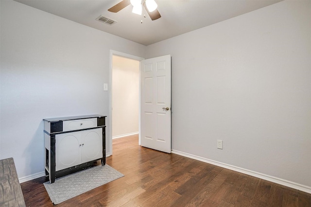 empty room featuring ceiling fan and dark hardwood / wood-style flooring