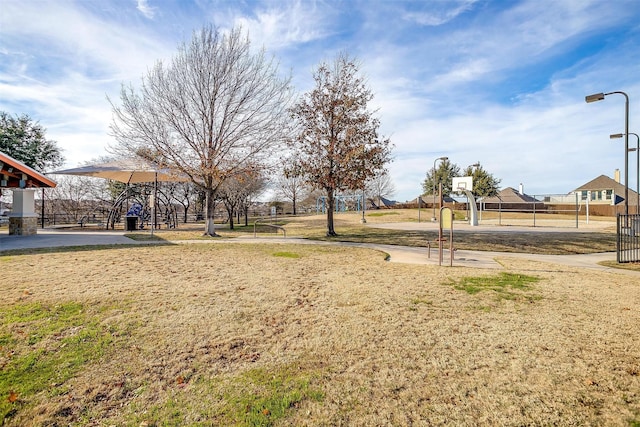 view of yard with basketball hoop