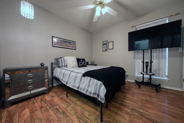 bedroom with dark hardwood / wood-style floors, ceiling fan, and lofted ceiling