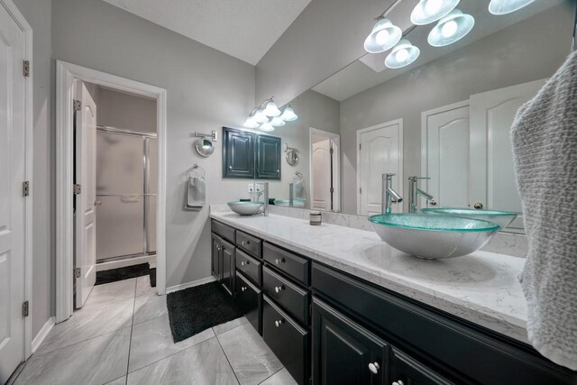 bathroom featuring vanity and an enclosed shower