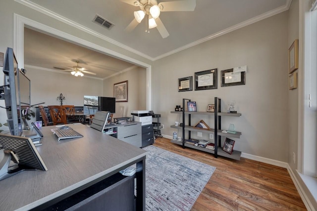 office space with crown molding, ceiling fan, and hardwood / wood-style flooring