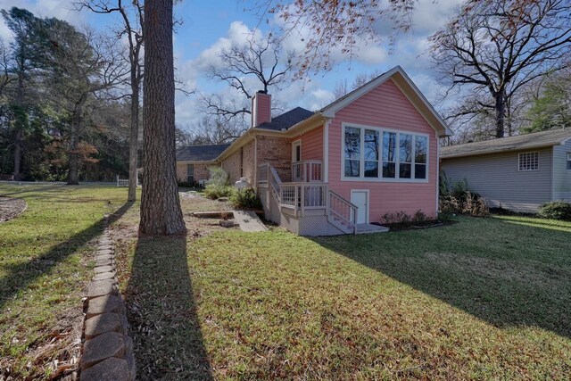 view of side of home featuring a yard