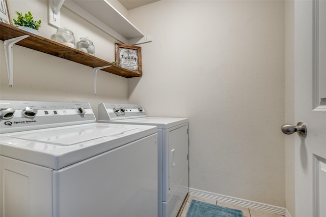 laundry room with washing machine and dryer and light tile patterned flooring