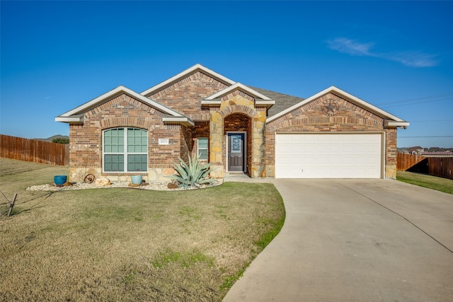 ranch-style house featuring a garage and a front yard