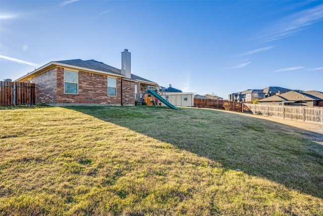 view of yard featuring a storage unit