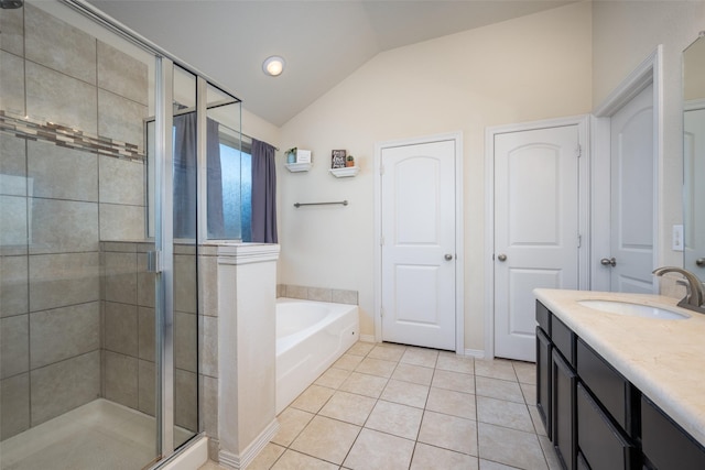 bathroom with tile patterned flooring, vanity, separate shower and tub, and vaulted ceiling