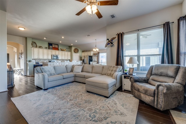 living room featuring ceiling fan and dark wood-type flooring