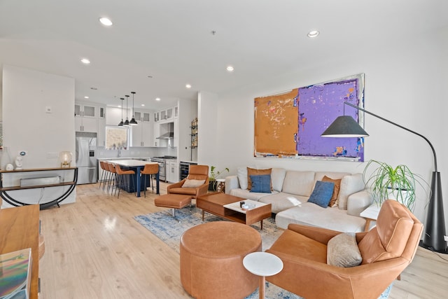 living room with sink and light hardwood / wood-style flooring