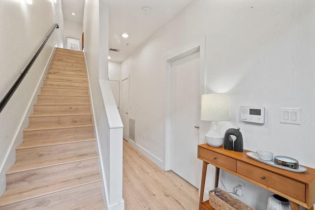 staircase with wood-type flooring