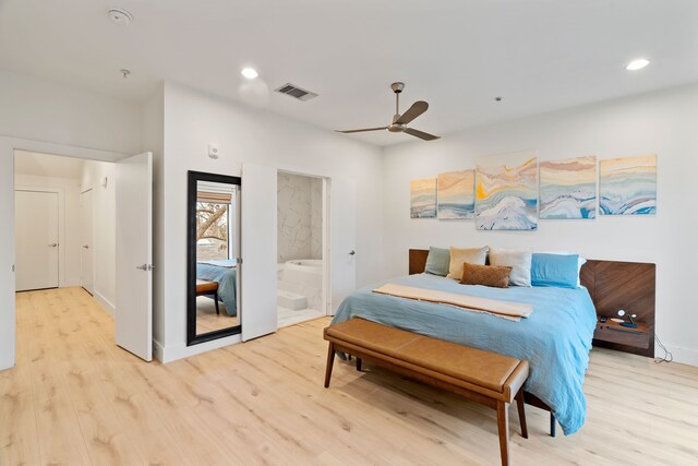 bedroom featuring connected bathroom, ceiling fan, and light hardwood / wood-style flooring