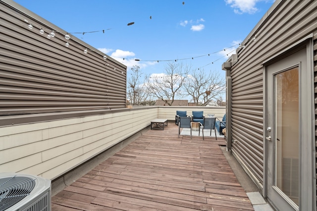 wooden deck featuring central AC unit