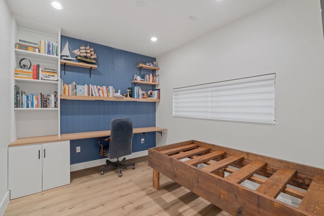 bedroom with light hardwood / wood-style flooring and built in desk