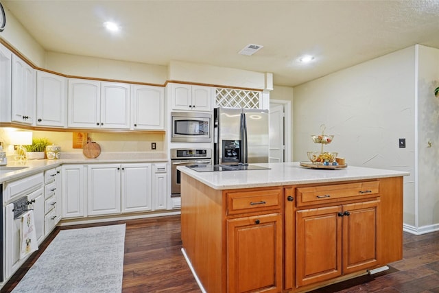 kitchen with dark wood-type flooring, white cabinetry, a center island, and stainless steel appliances