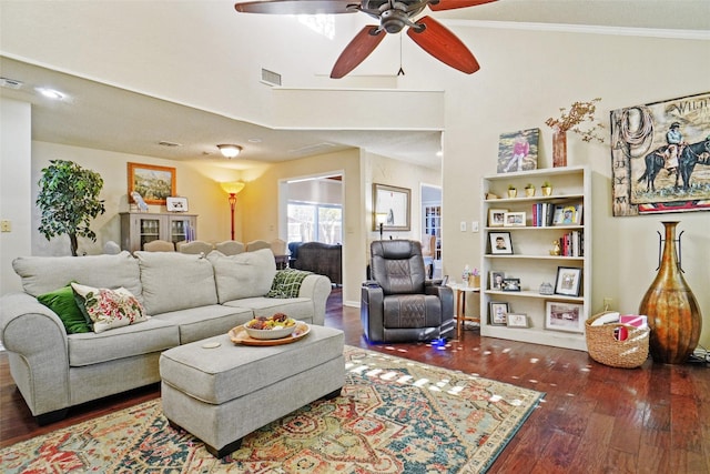 living room featuring dark hardwood / wood-style floors, ceiling fan, and crown molding