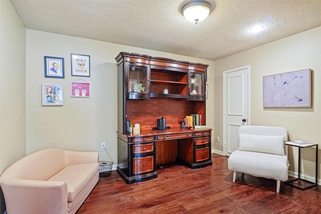 office space with a textured ceiling and dark hardwood / wood-style flooring