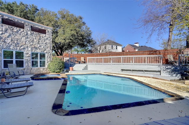 view of pool featuring an in ground hot tub and a wooden deck