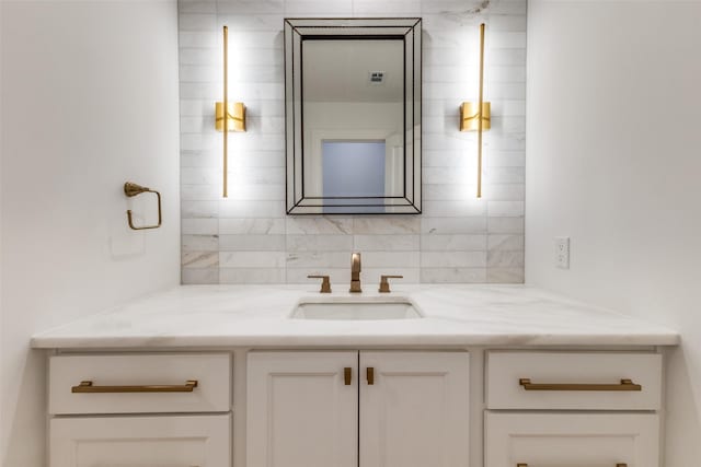 bathroom with tasteful backsplash and vanity