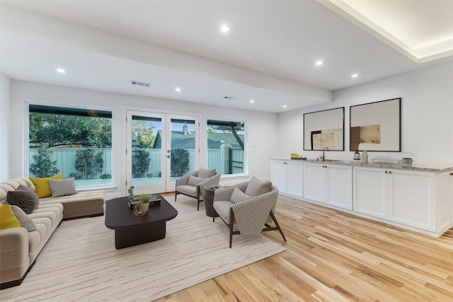 living room with sink and light hardwood / wood-style floors