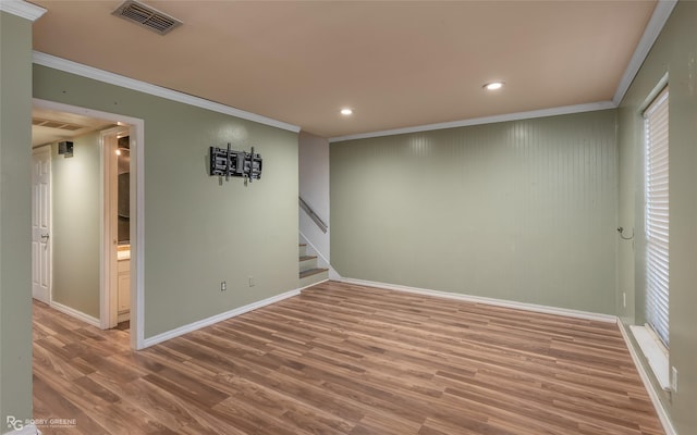 unfurnished room featuring hardwood / wood-style flooring and ornamental molding