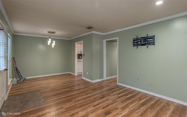 empty room with crown molding and dark wood-type flooring