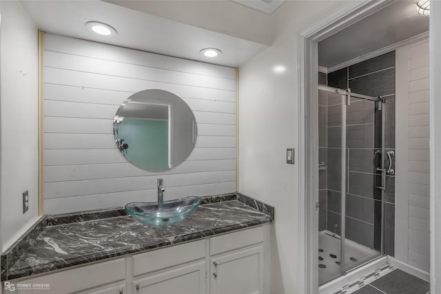 bathroom featuring tile patterned floors, vanity, an enclosed shower, and ornamental molding