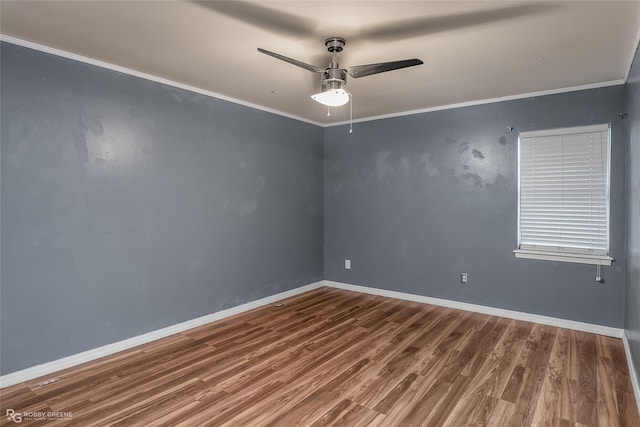 empty room with ceiling fan, wood-type flooring, and ornamental molding