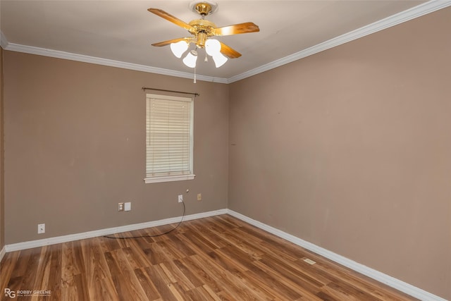 spare room with hardwood / wood-style floors, ornamental molding, and ceiling fan