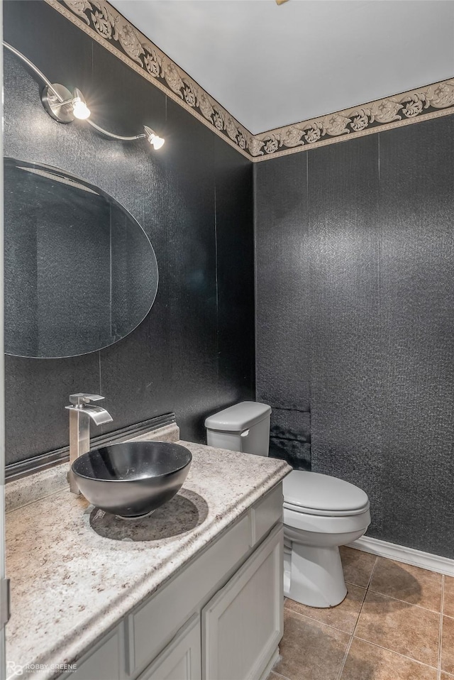 bathroom featuring tile patterned flooring, vanity, and toilet