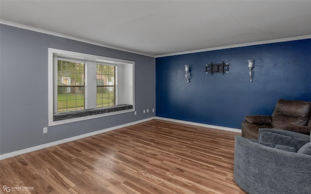 unfurnished room with ornamental molding and hardwood / wood-style floors