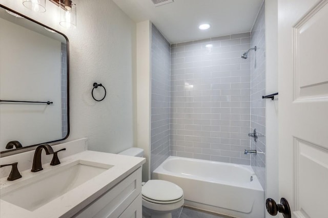 full bathroom featuring tiled shower / bath combo, vanity, and toilet