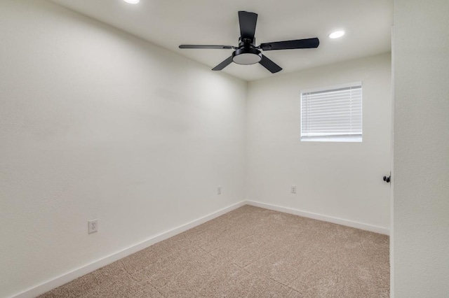 carpeted spare room with ceiling fan