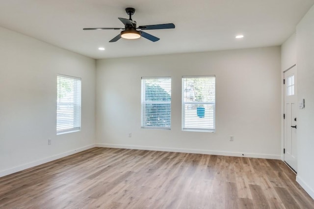 spare room featuring light hardwood / wood-style floors and ceiling fan