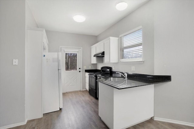 kitchen with ventilation hood, sink, white refrigerator, white cabinetry, and black electric range oven