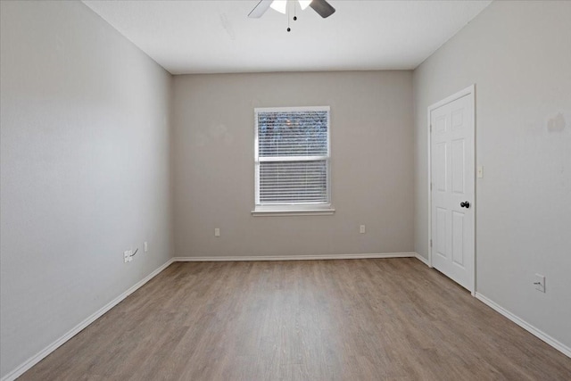 empty room featuring hardwood / wood-style flooring and ceiling fan