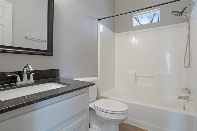 full bathroom with shower / bathing tub combination, vanity, hardwood / wood-style flooring, and toilet