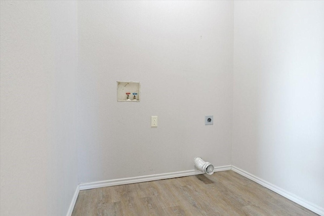 clothes washing area featuring hookup for an electric dryer, washer hookup, and light wood-type flooring