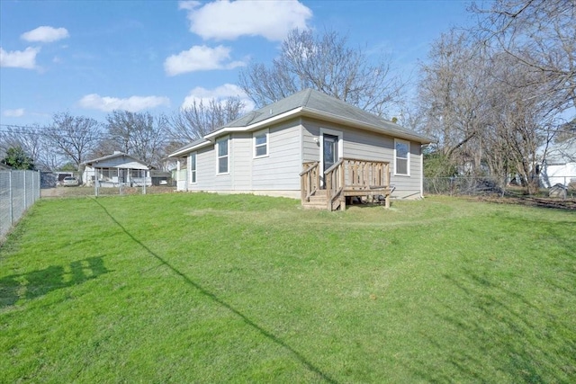 rear view of property featuring a yard