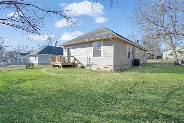 back of house featuring a deck, a yard, and central air condition unit