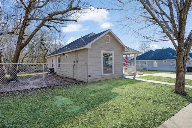 view of side of home featuring a yard