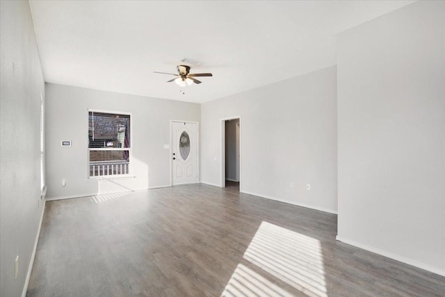 empty room featuring ceiling fan and dark wood-type flooring