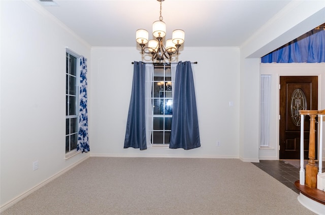 carpeted empty room with a notable chandelier and ornamental molding