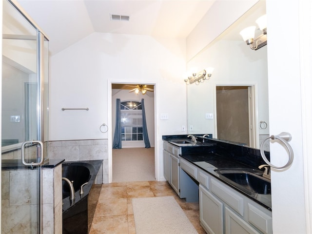 bathroom featuring a bath, vanity, ceiling fan, and lofted ceiling