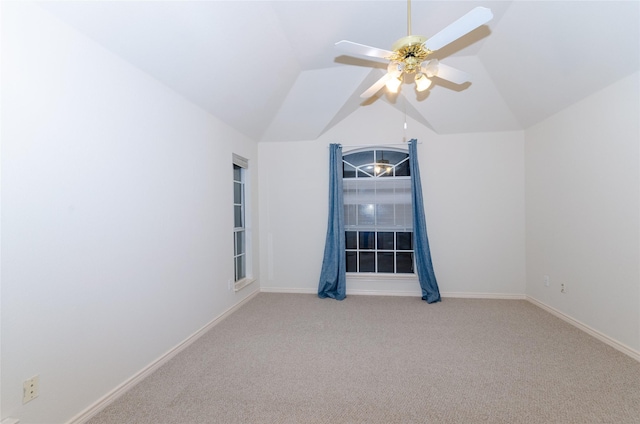 carpeted empty room featuring ceiling fan and vaulted ceiling