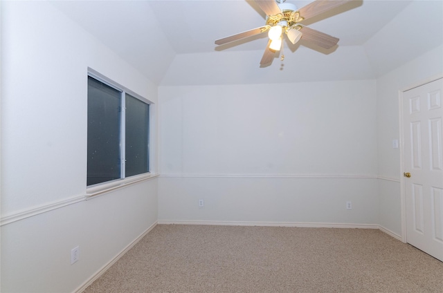 carpeted spare room with ceiling fan and lofted ceiling