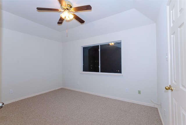 spare room featuring carpet flooring, ceiling fan, and vaulted ceiling